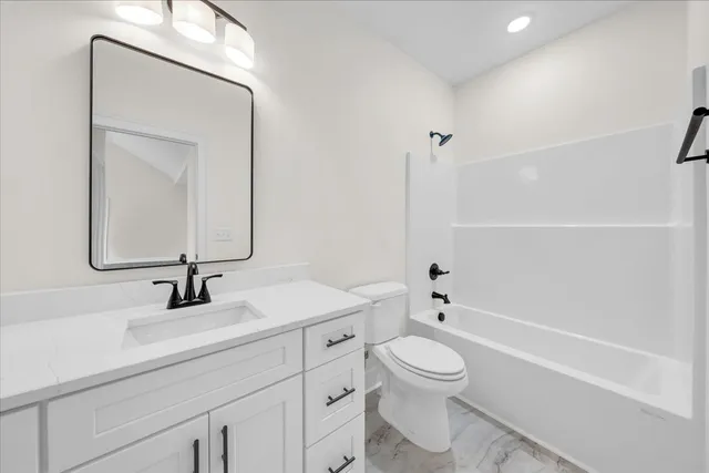 a bathroom with a toilet a sink and a mirror