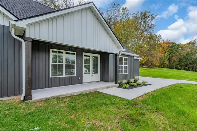 a front view of a house with a garden