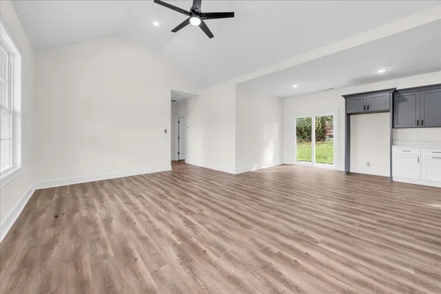 wooden floor in an empty room with a window