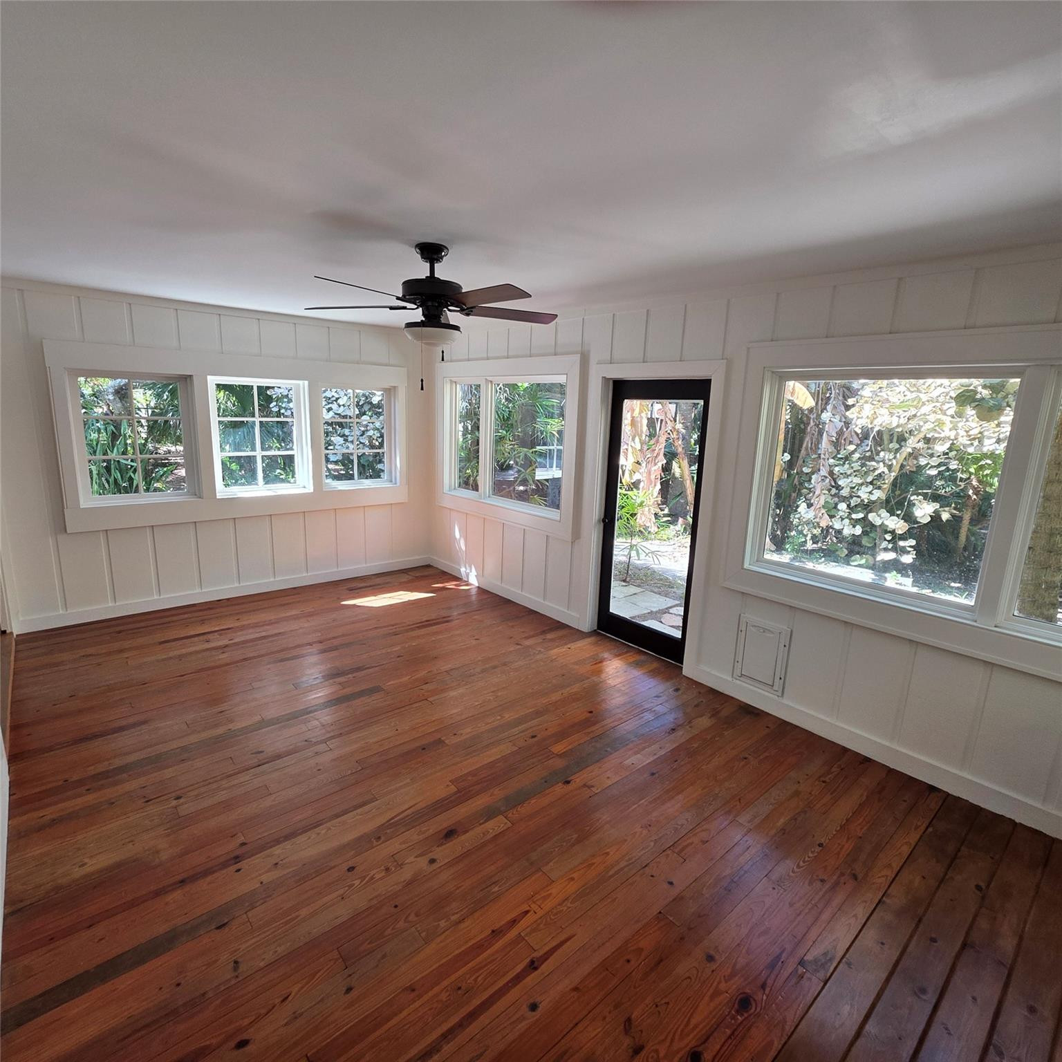 722 Wentworth Street Sebastian, FL 32958 - Photo 12 of 16 a view of an empty room with wooden floor and a window