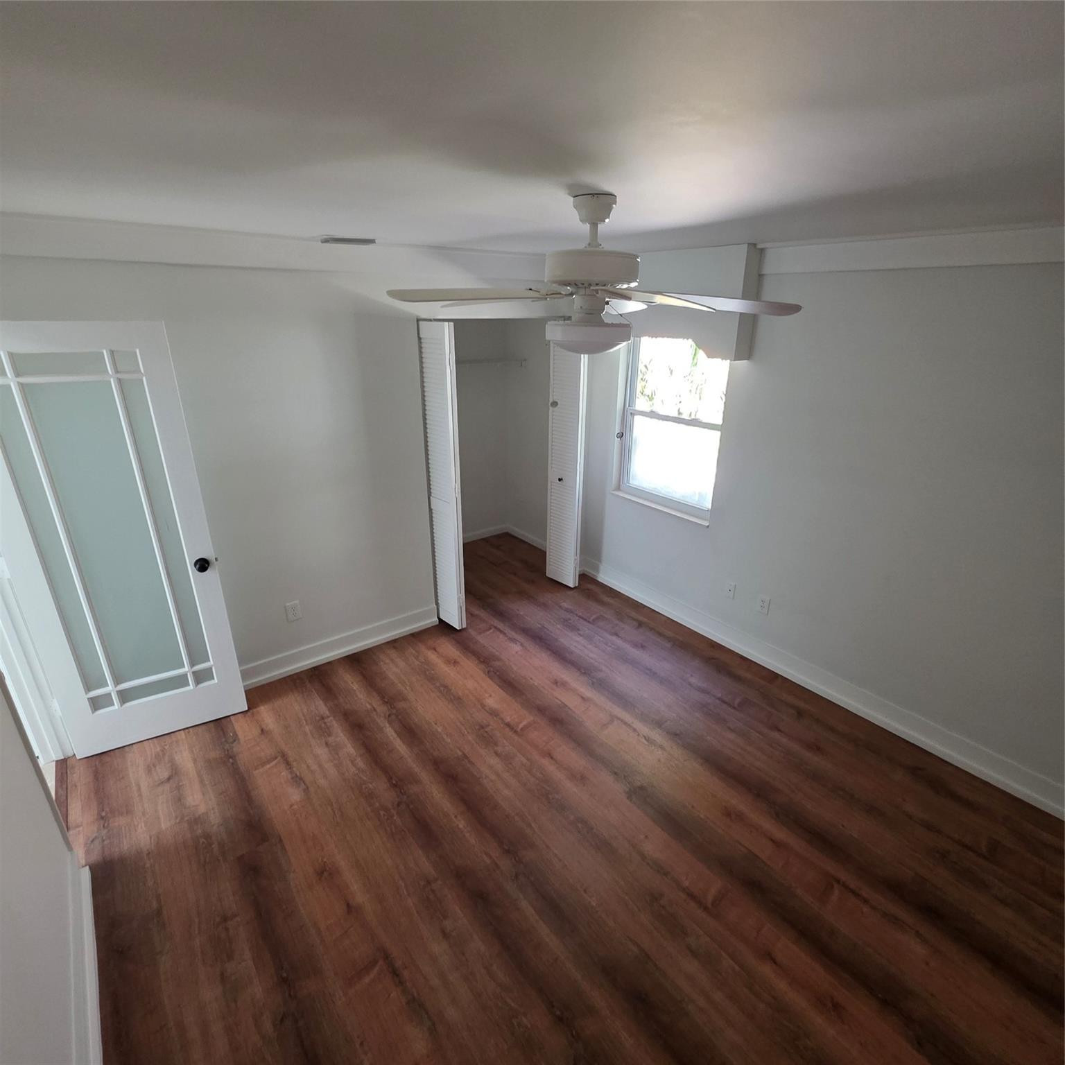 722 Wentworth Street Sebastian, FL 32958 - Photo 4 of 16 an empty room with wooden floor and windows