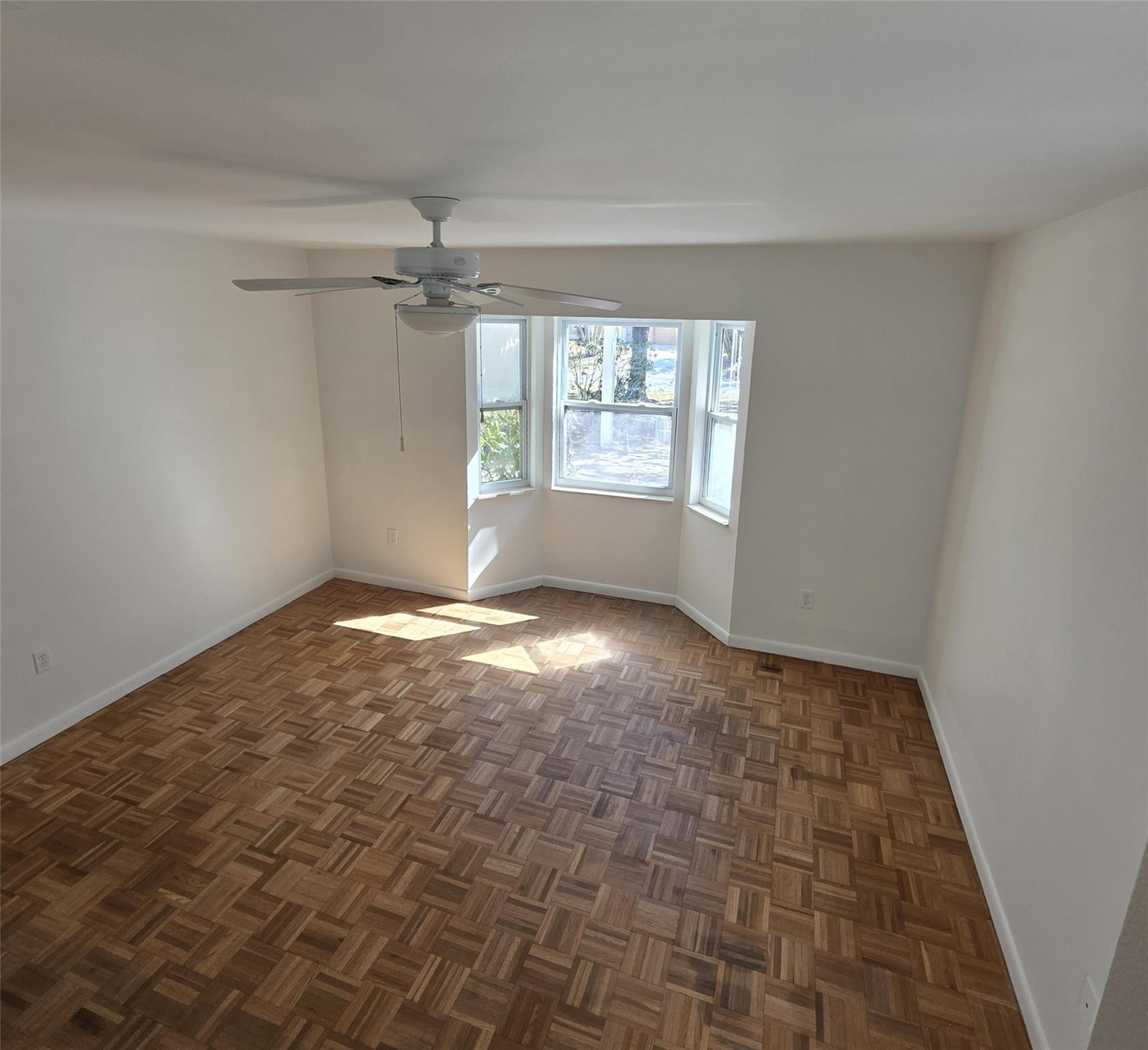 722 Wentworth Street Sebastian, FL 32958 - Photo 5 of 16 an empty room with windows and fan