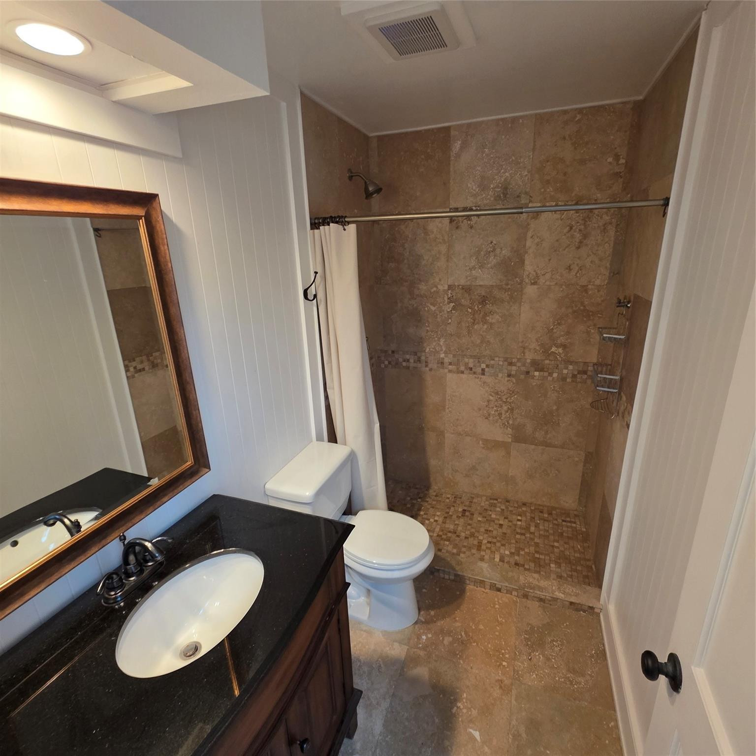 722 Wentworth Street Sebastian, FL 32958 - Photo 6 of 16 a bathroom with a sink a toilet a mirror and shower