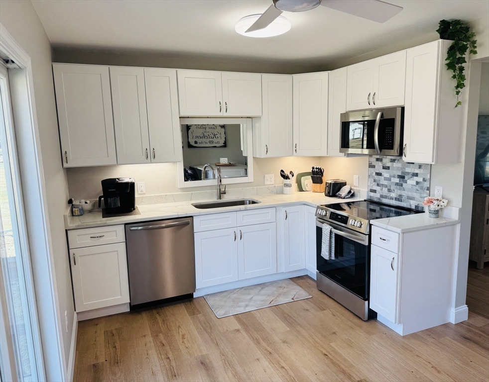 31 Deane Road Bernardston, MA 01337 - Photo 19 of 35 a kitchen with granite countertop white cabinets and stainless steel appliances