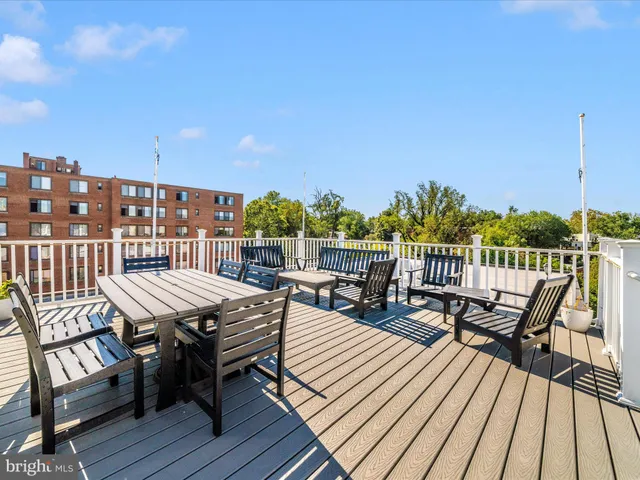 a view of a balcony with wooden benches