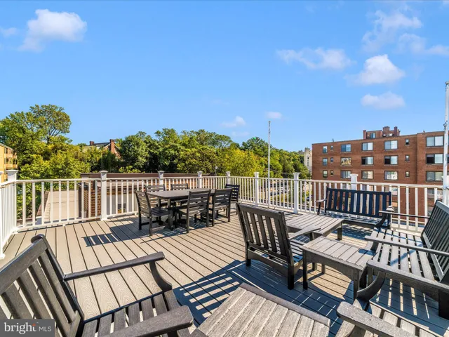 a view of a patio with table and chairs with wooden fence