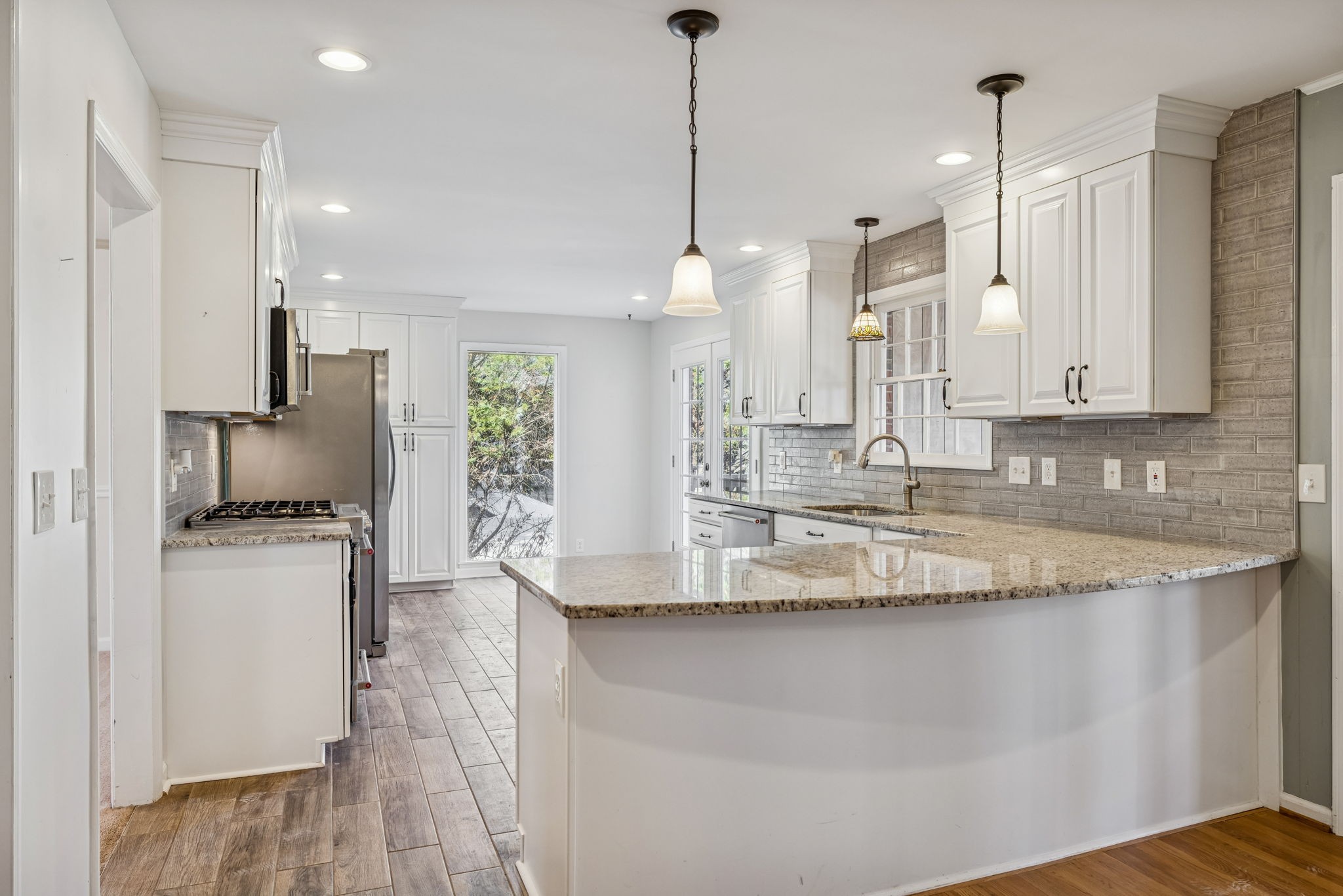 2234 Isaac Lane Franklin, TN 37064 - Photo 21 of 92 a kitchen with stainless steel appliances granite countertop a sink a stove a refrigerator a center island and cabinets