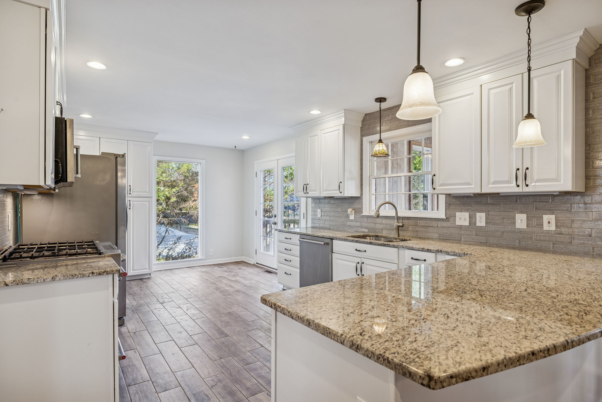 2234 Isaac Lane Franklin, TN 37064 - Photo 23 of 92 a kitchen with stainless steel appliances granite countertop a sink a stove and a refrigerator