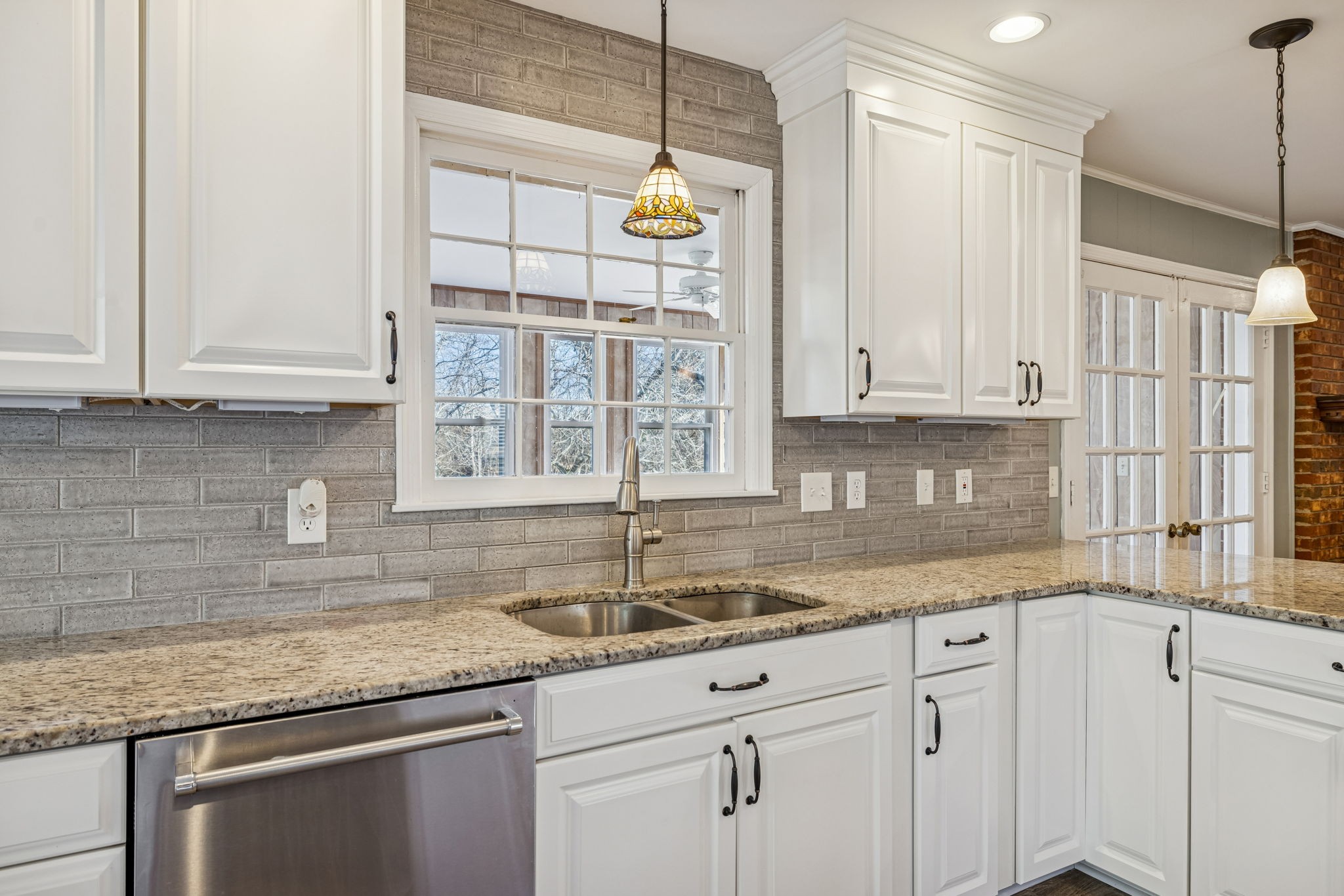 2234 Isaac Lane Franklin, TN 37064 - Photo 26 of 92 a kitchen with kitchen island granite countertop a sink a window and cabinets