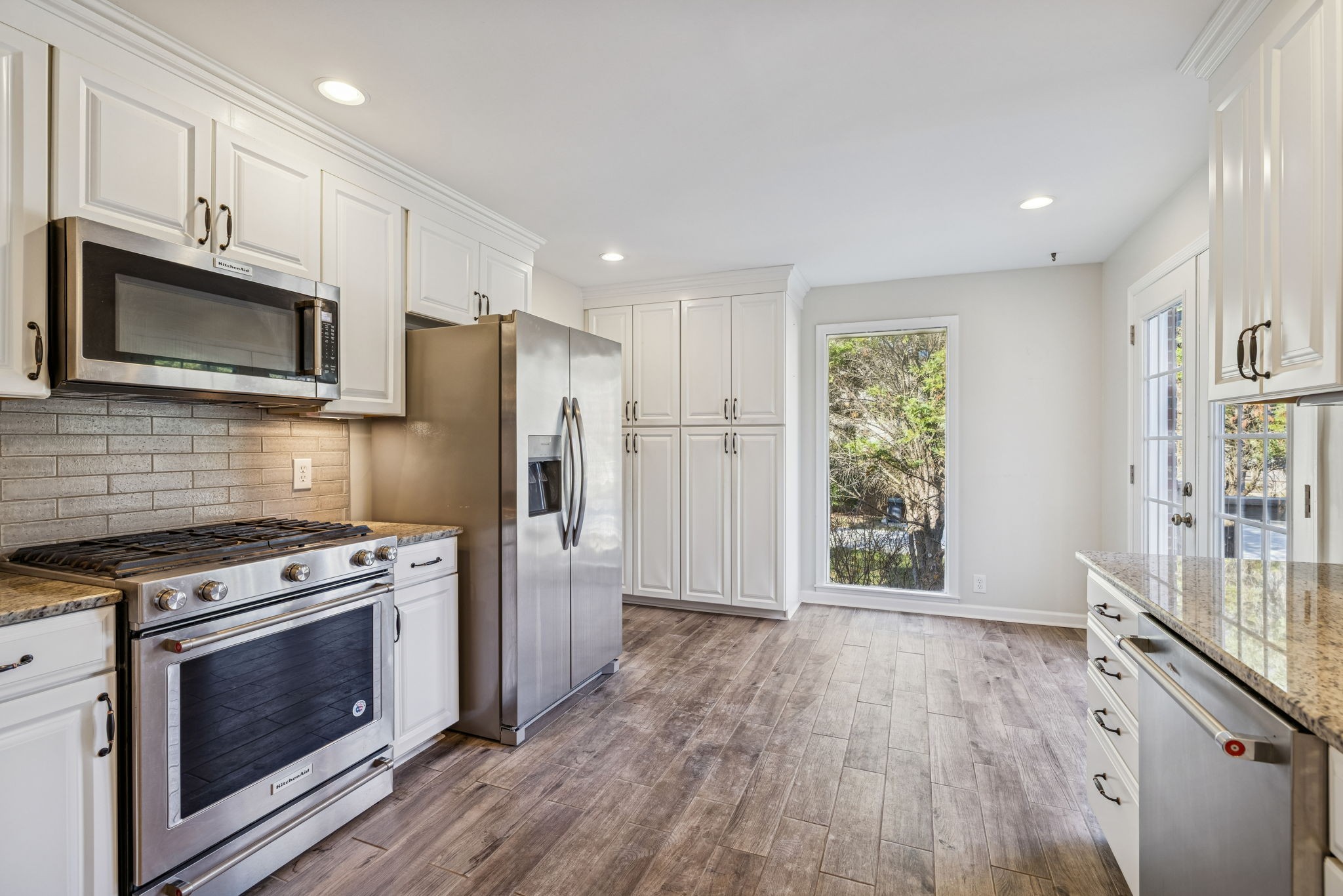 2234 Isaac Lane Franklin, TN 37064 - Photo 30 of 92 a kitchen with stainless steel appliances granite countertop a stove a refrigerator and a microwave