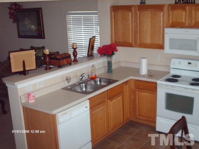 3706 Marshlane Way Raleigh, NC 27610 - Photo 22 of 22 a kitchen with a sink stove and cabinets
