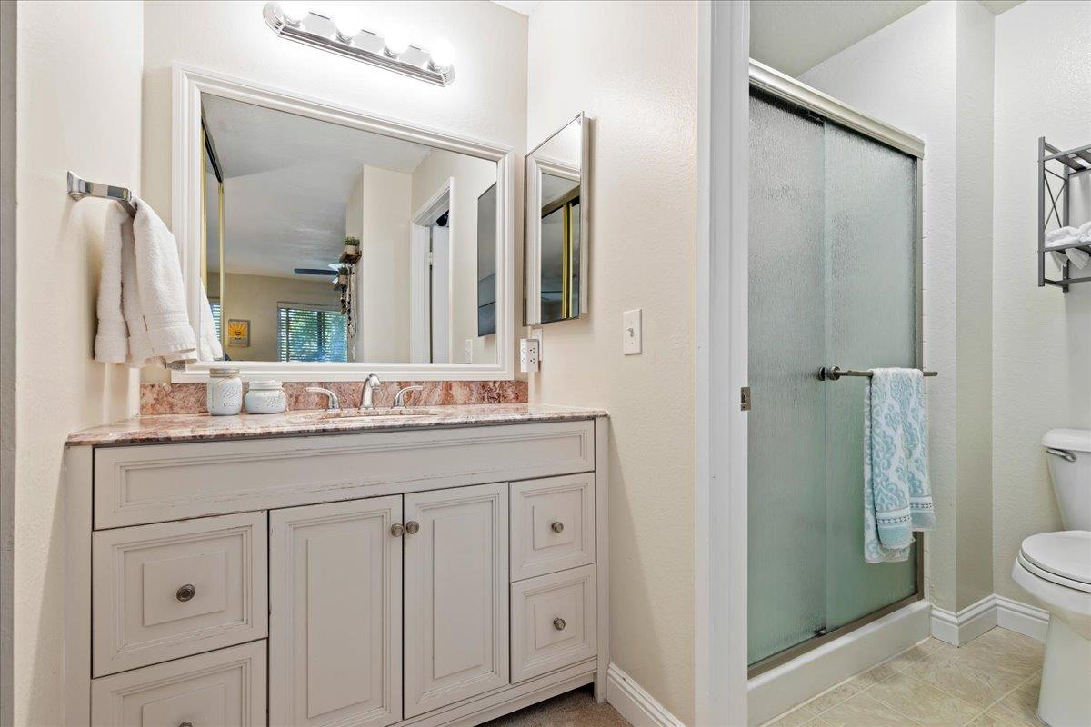 208 Compton Circle, Unit C San Ramon, CA 94583 - Photo 12 of 20 a bathroom with a granite countertop sink a toilet and a mirror