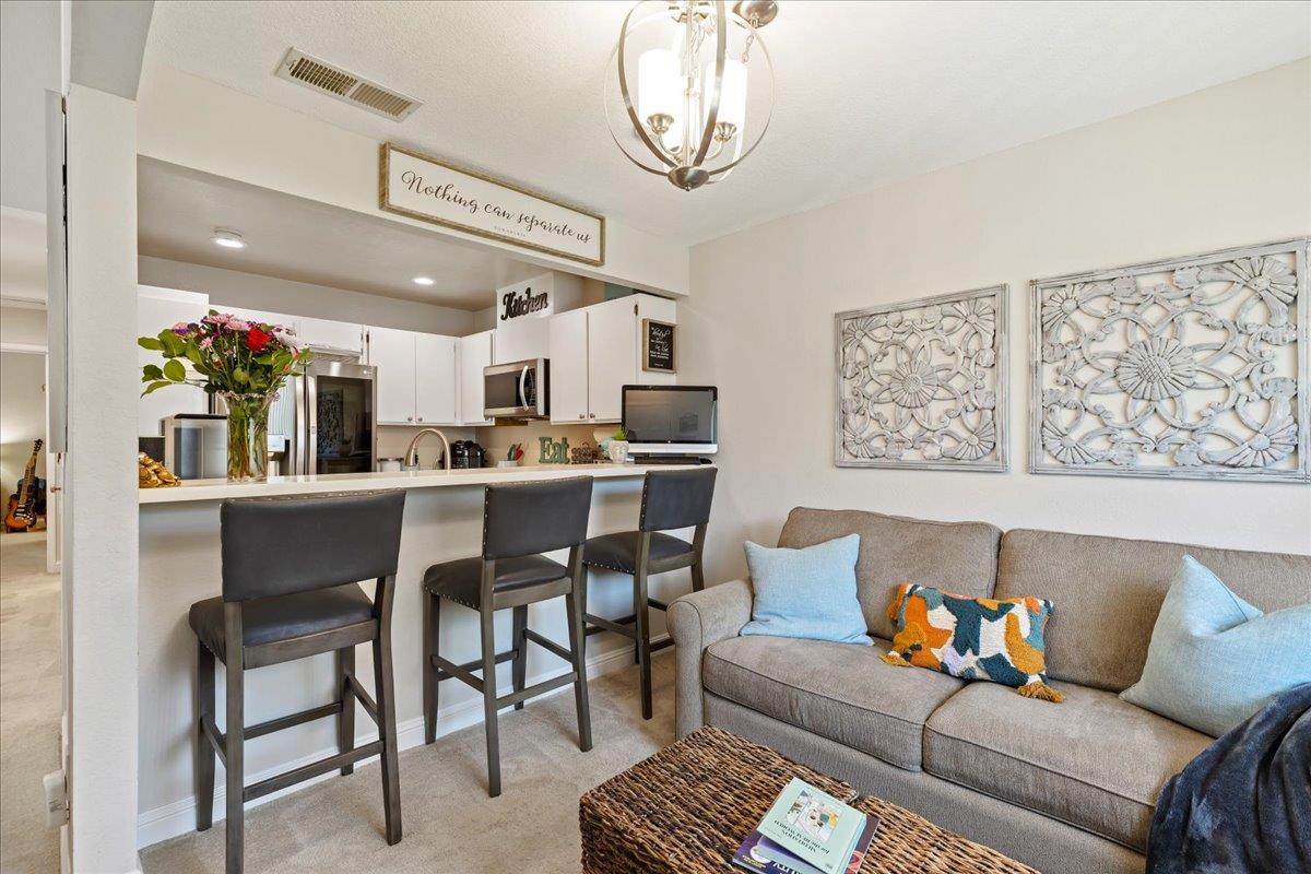 208 Compton Circle, Unit C San Ramon, CA 94583 - Photo 6 of 20 a living room with furniture and a chandelier