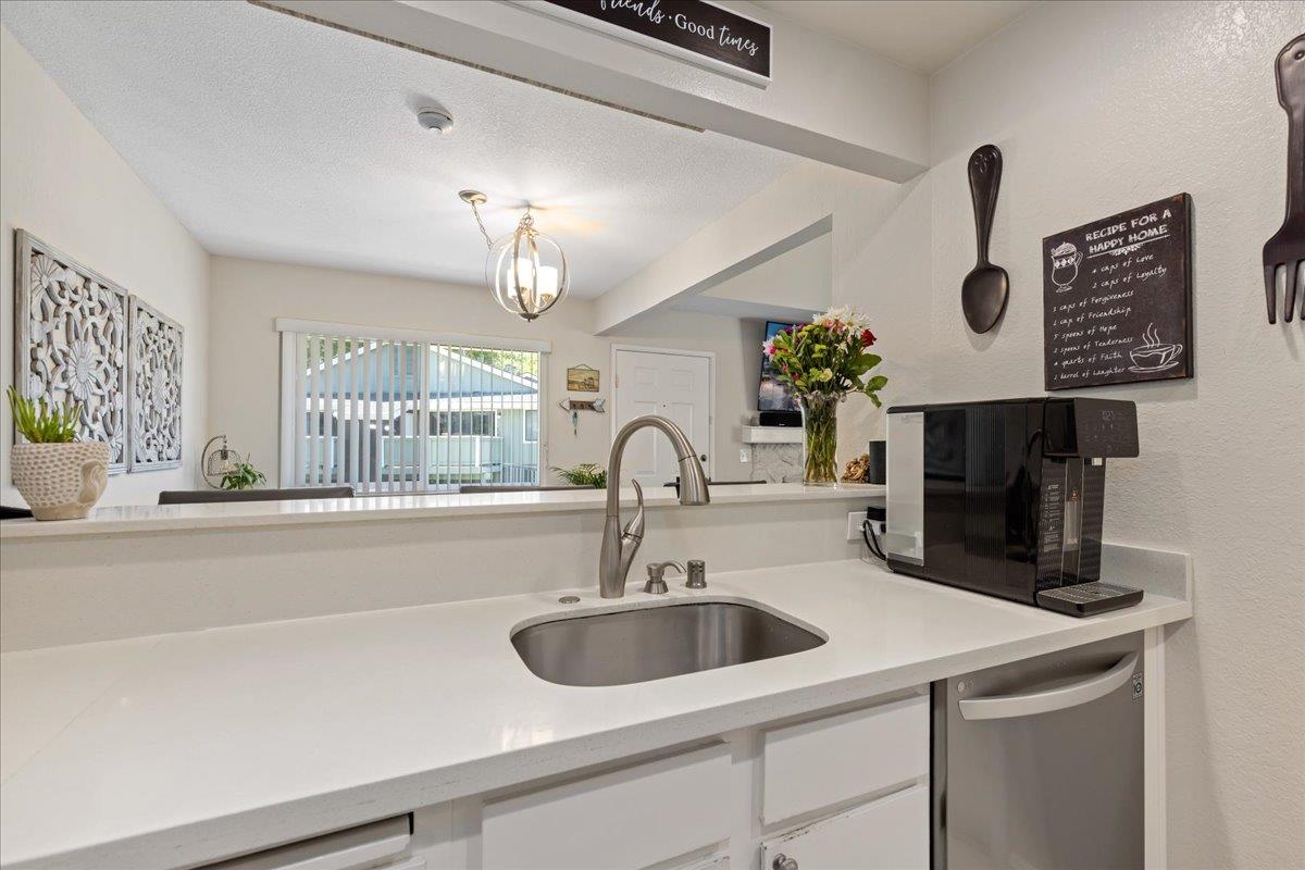 208 Compton Circle, Unit C San Ramon, CA 94583 - Photo 8 of 20 a sink with a faucet a chandelier and kitchen view