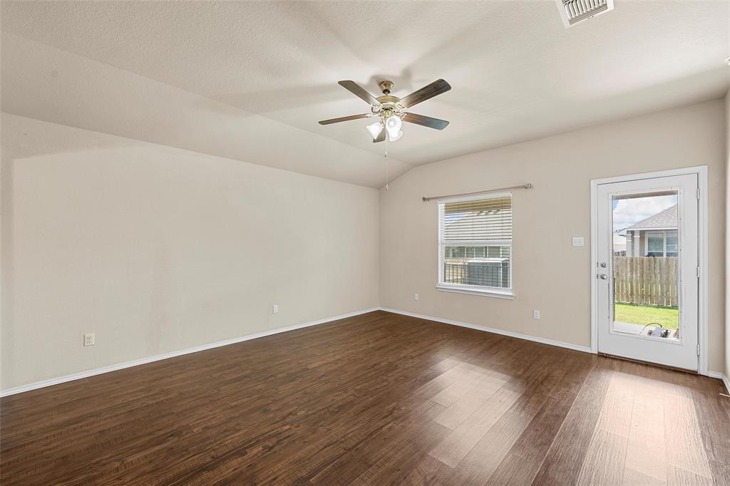 3217 Beutel Road Lorena, TX 76655 - Photo 16 of 40 Empty room featuring dark wood finished floors, ceiling fan, and vaulted ceiling