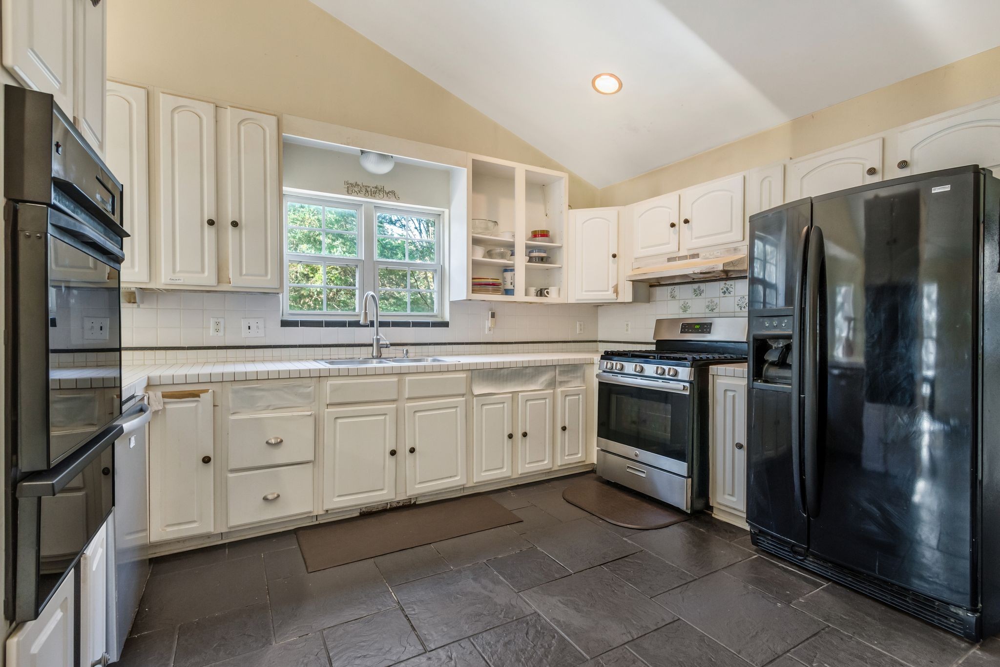 7164 Dice Lampley Road Fairview, TN 37062 - Photo 12 of 42 a kitchen with granite countertop white cabinets a refrigerator a sink a stove and white cabinets