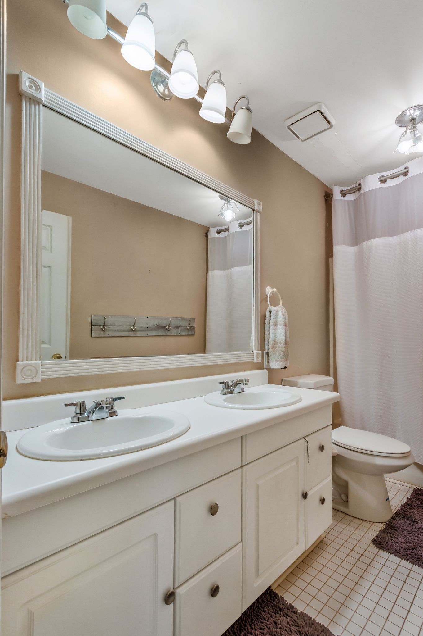 7164 Dice Lampley Road Fairview, TN 37062 - Photo 25 of 42 a bathroom with a sink a toilet and a mirror