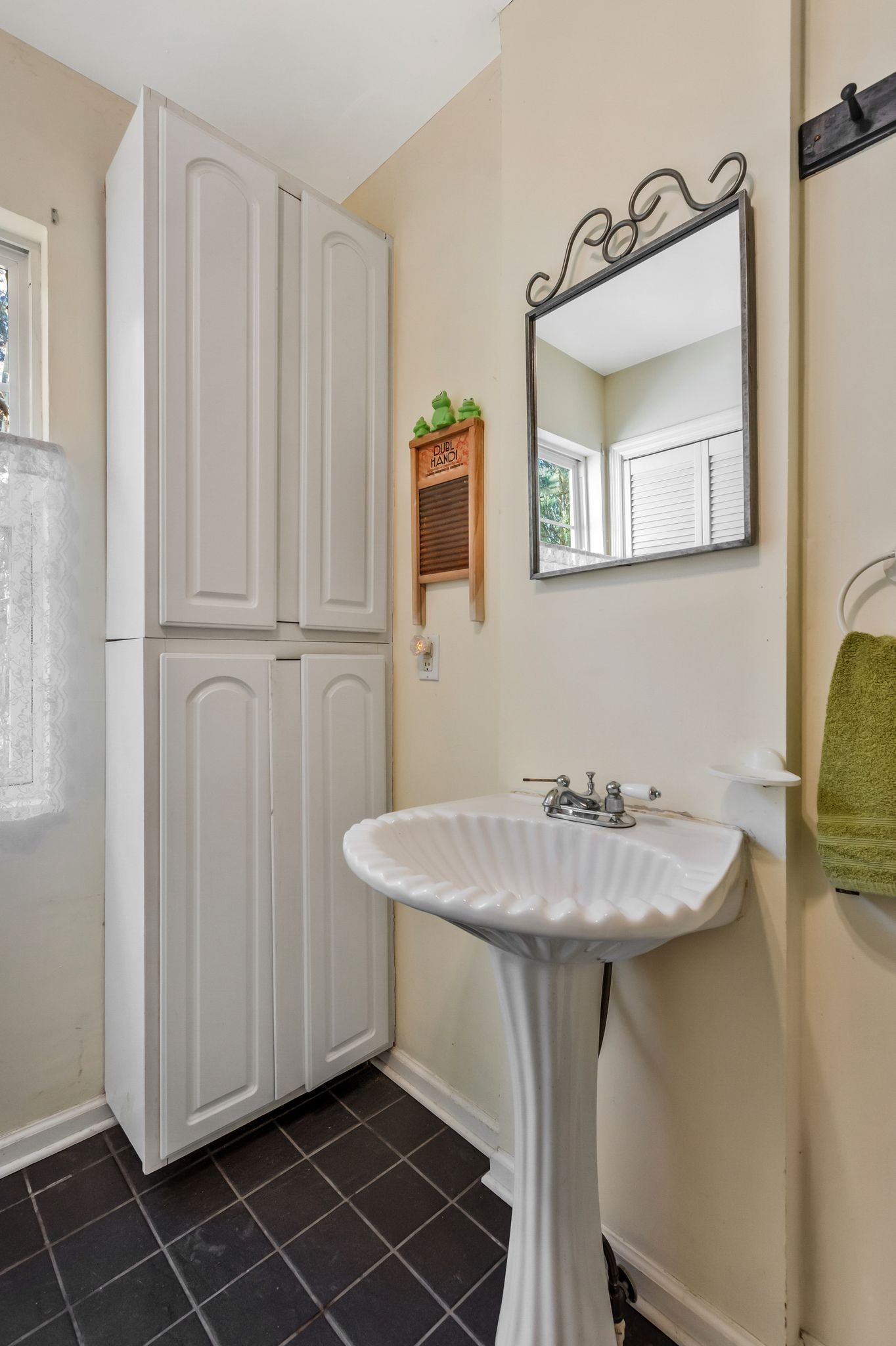 7164 Dice Lampley Road Fairview, TN 37062 - Photo 30 of 42 a bathroom with a sink and a mirror