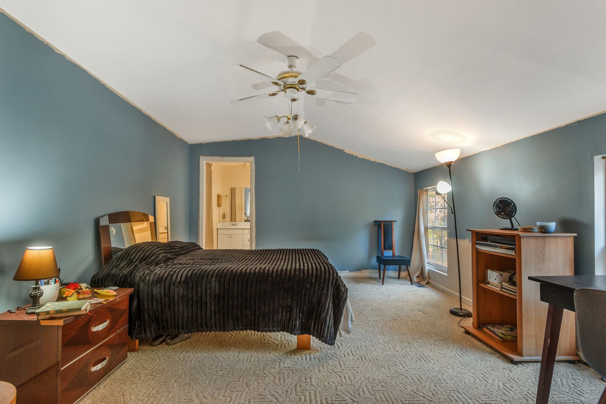 7164 Dice Lampley Road Fairview, TN 37062 - Photo 35 of 42 a bedroom with a bed and a chandelier