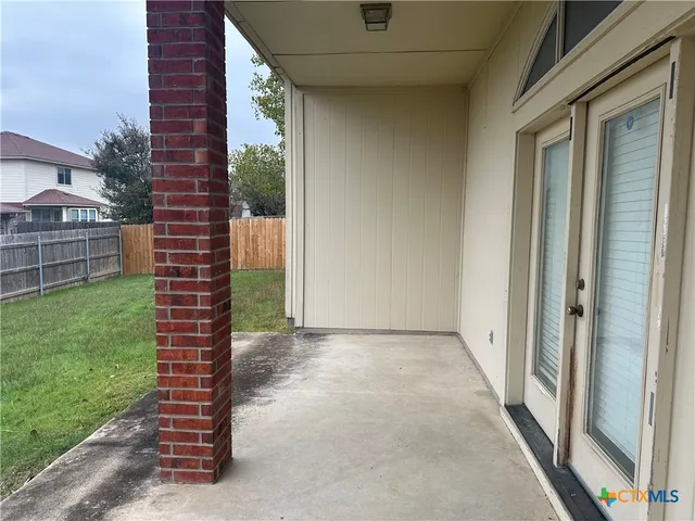 a view of a yard from a corridor