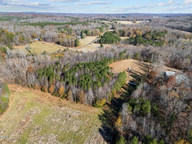 a view of a yard with wooden fence
