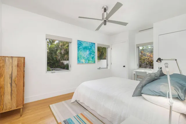 a bedroom with a bed mirror and window