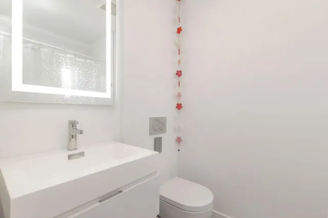 a bathroom with a sink a toilet and a window