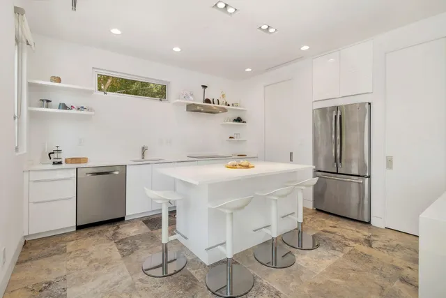 a kitchen with a sink appliances and cabinets
