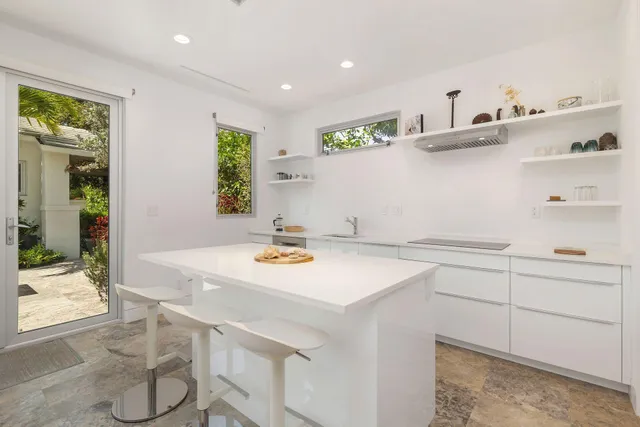 a kitchen with a sink cabinets and wooden floor