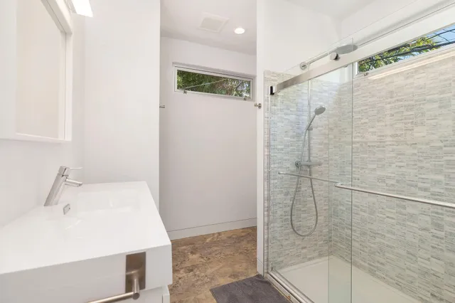 a bathroom with a sink and shower