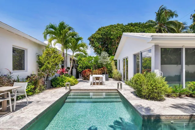 a view of a house with backyard sitting area and garden