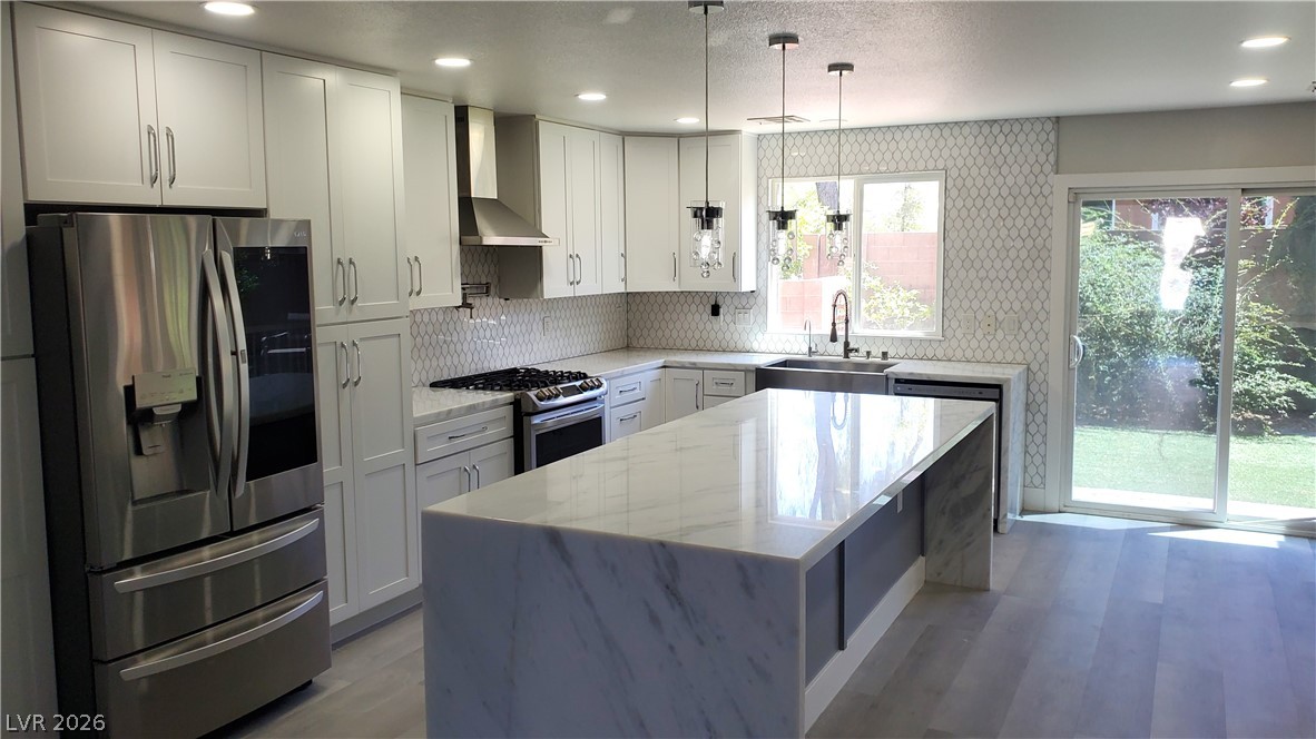 7903 Dell Ridge Avenue Las Vegas, NV 89179 - Photo 2 of 20 Culinary delights await in this sleek kitchen, complete with a generous island and ample counter space.