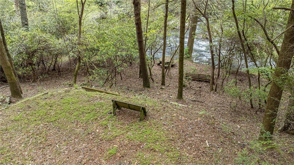 Lot 48 Indian Cave Road Ellijay, GA 30536 - Photo 4 of 10 a backyard of a house with table and chairs