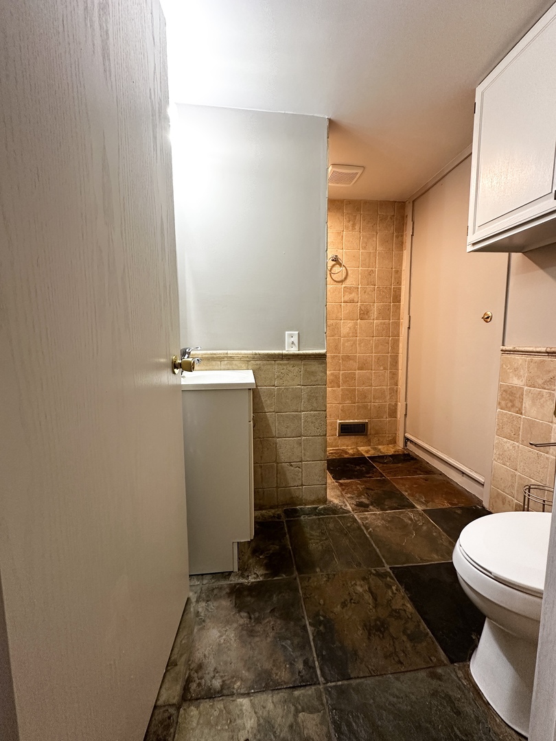 5N769 Pearson Drive, Unit 2 Wayne, IL 60184 - Photo 11 of 15 a bathroom with a sink a toilet and shower