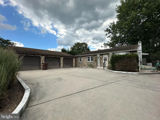 front view of a house with a yard and garage