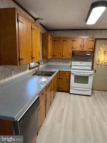 a kitchen with stainless steel appliances a stove sink and cabinets