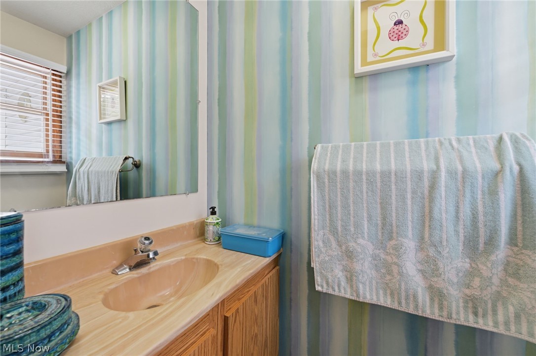 1499 Morris Road Kent, OH 44240 - Photo 27 of 41 Vanity with integrated sink, wood cabinetry, and a large wall-mounted mirror
