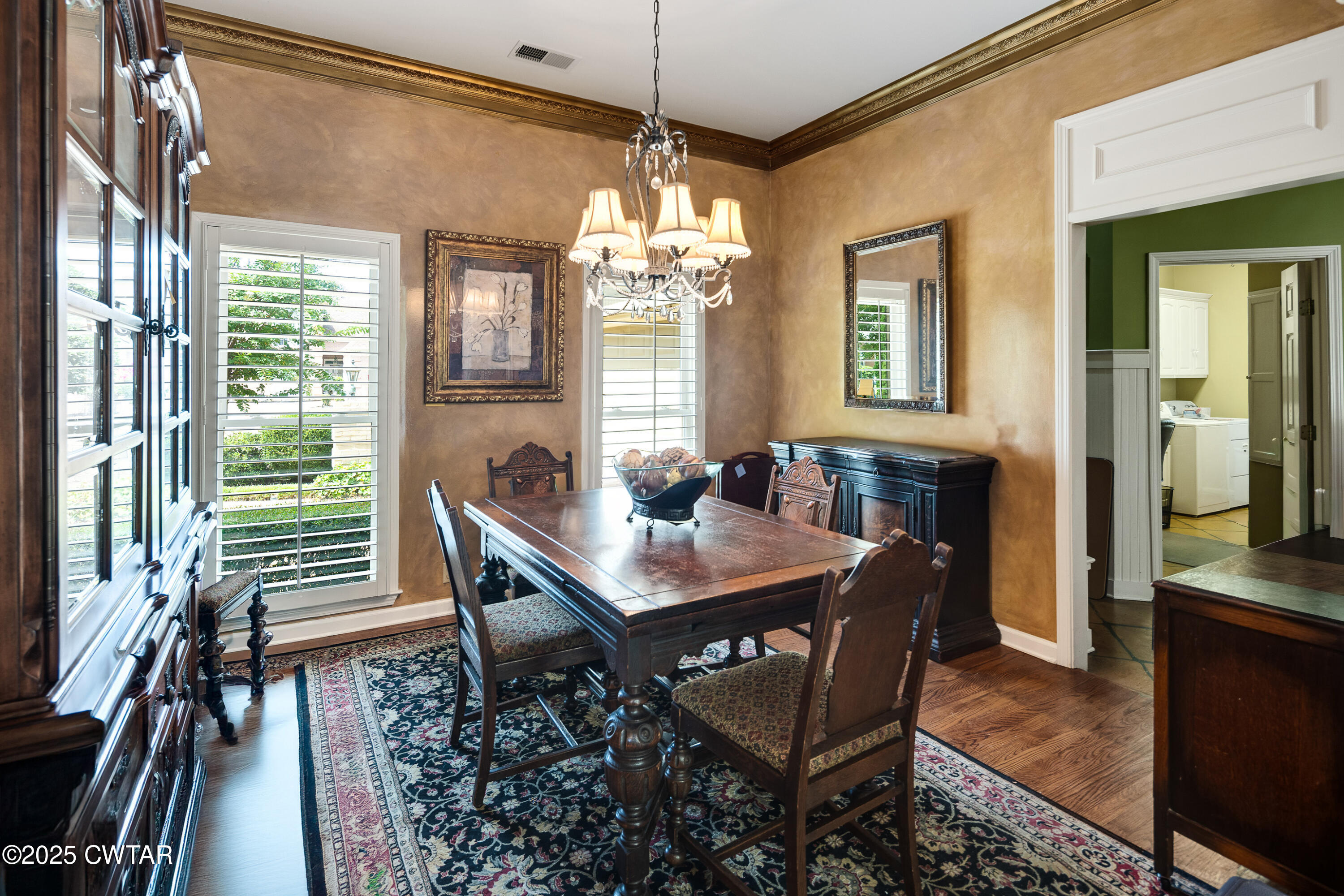 1647 Forsythe Trail Collierville, TN 38017 - Photo 14 of 32 a dining room with furniture a chandelier and wooden floor