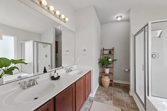 a bathroom with a sink double vanity and a shower