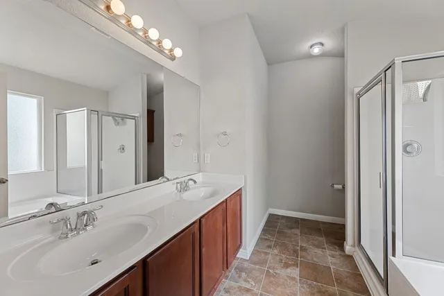 a spacious bathroom with a double vanity sink mirror and double