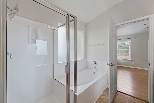 a bathroom with a bathtub and a shower