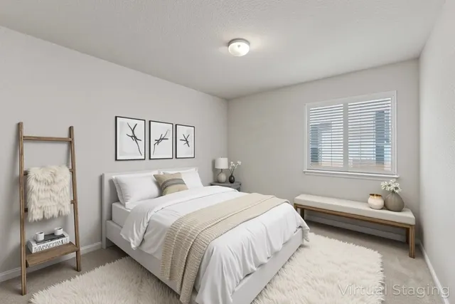 a spacious bedroom with a bed and a couch