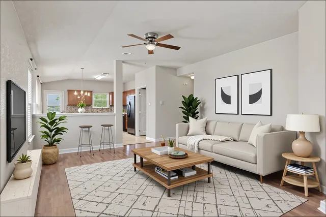 a living room with furniture and a chandelier