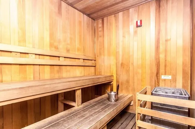 a kitchen with a stove a refrigerator and a dining table with wooden floor