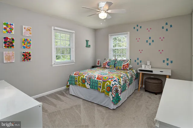 a bedroom with a bed a window and dresser