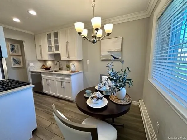 a view of a dining room with furniture and chandelier