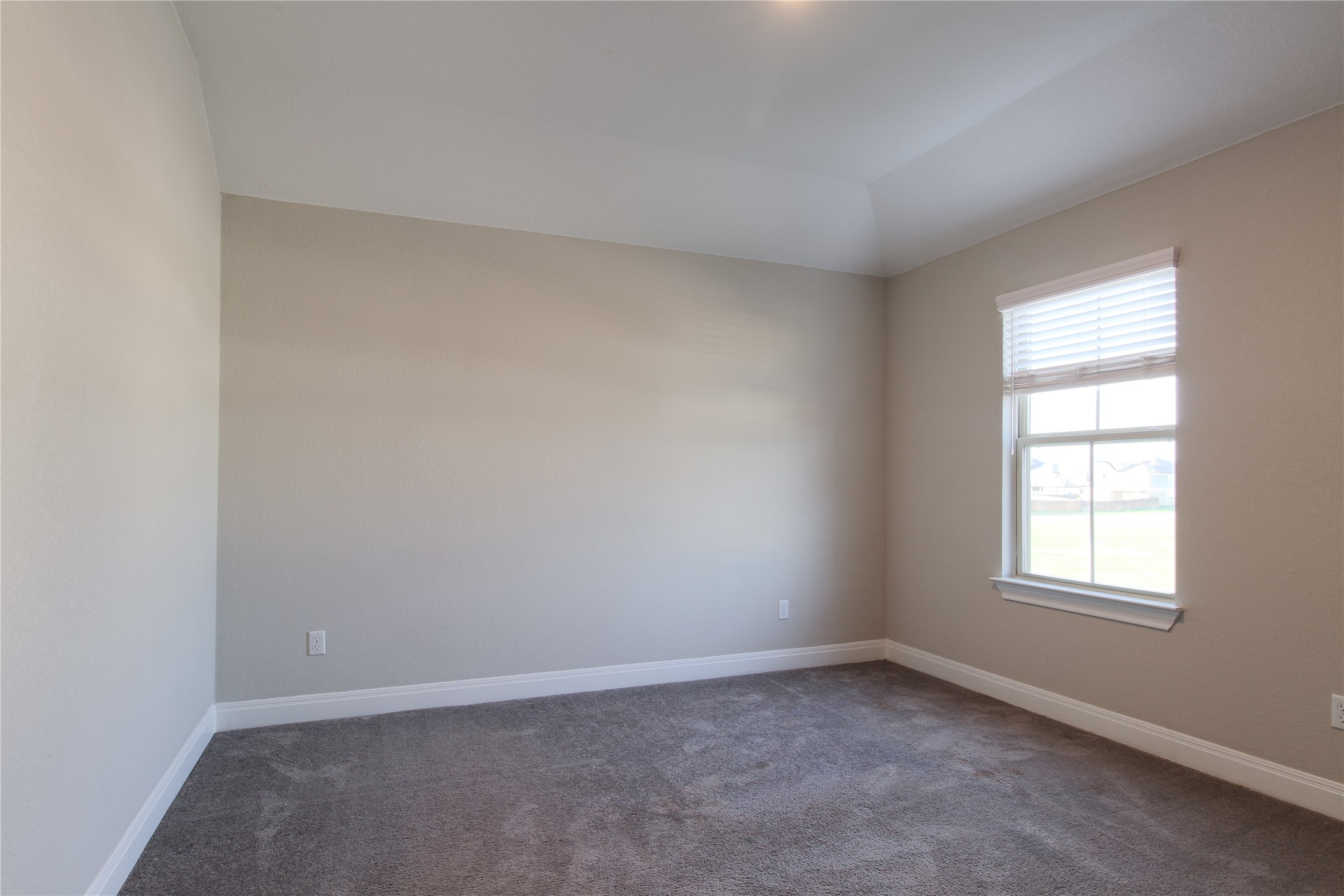 109 Yellow Thistle Cove Georgetown, TX 78626 - Photo 13 of 36 Neutral-toned room featuring a single window with blinds, tray ceiling, recessed lighting, and grey carpeting