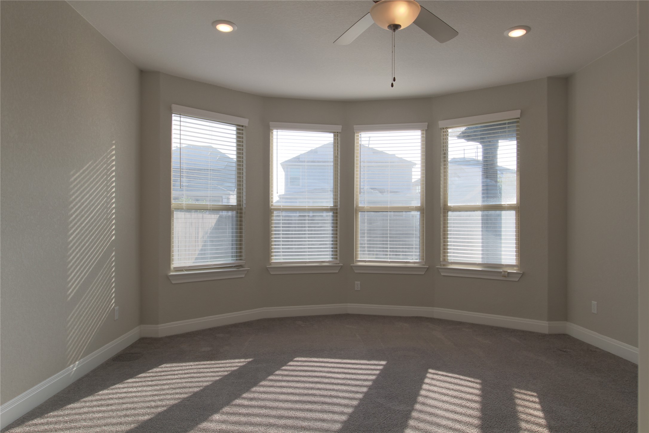 109 Yellow Thistle Cove Georgetown, TX 78626 - Photo 16 of 36 Bay window feature with four windows, carpet flooring, a ceiling fan, and recessed lighting