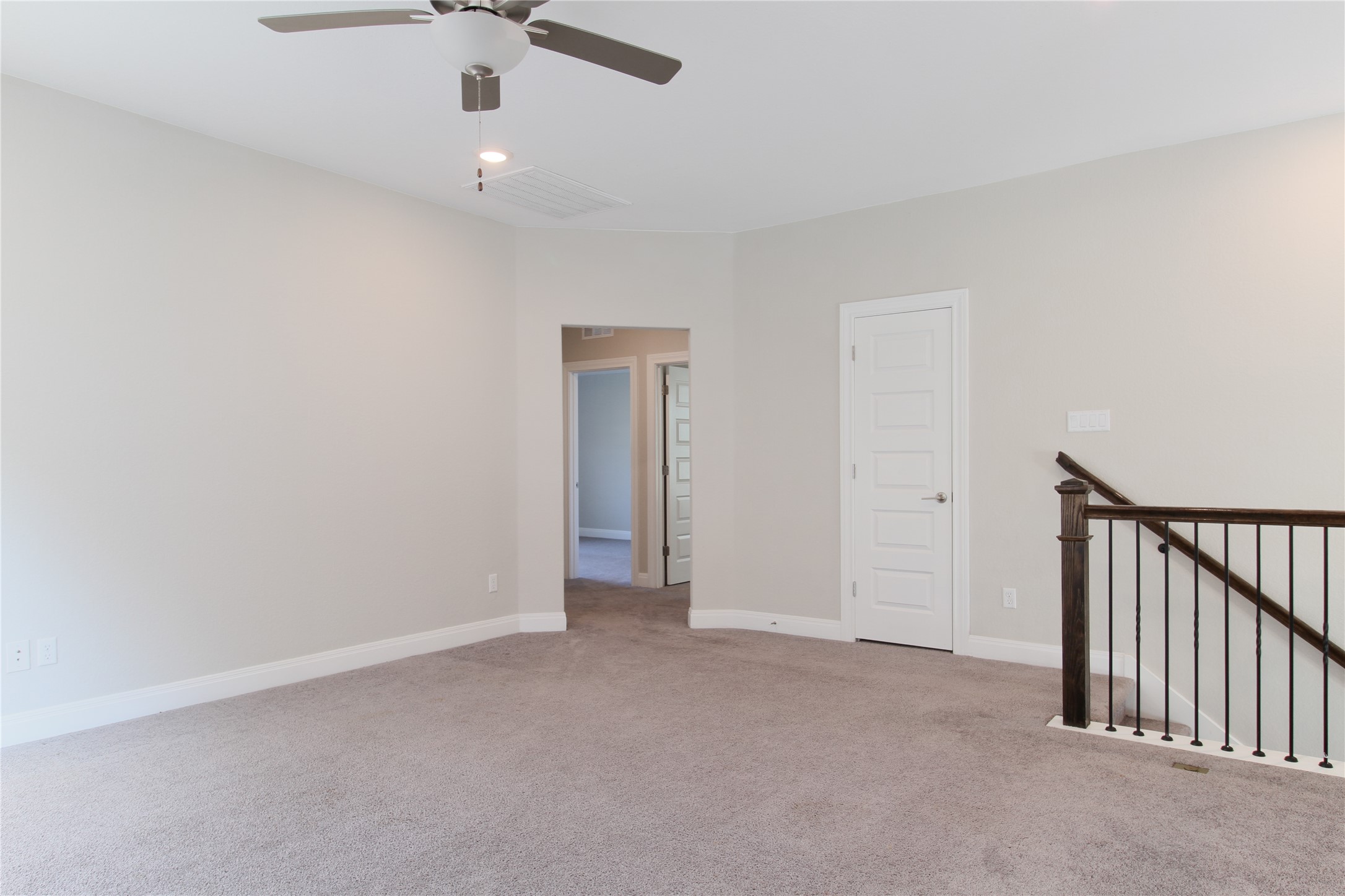 109 Yellow Thistle Cove Georgetown, TX 78626 - Photo 21 of 36 Open concept room featuring neutral carpeting, light-toned walls, and a ceiling fan with integrated lighting