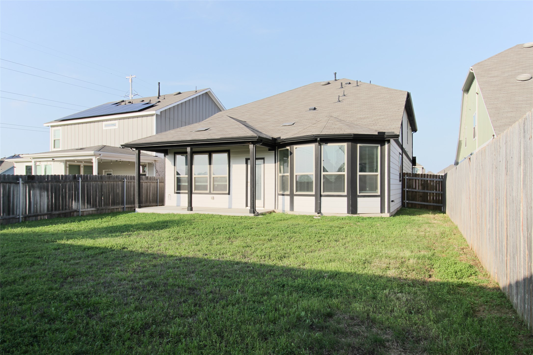 109 Yellow Thistle Cove Georgetown, TX 78626 - Photo 32 of 36 Spacious backyard featuring a manicured lawn, wood fencing, and a concrete patio
